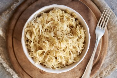 Homemade fermented cabbage or sauerkraut in a bowl, top view