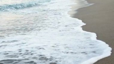 Waves forming on an empty sandy beach in Turkey