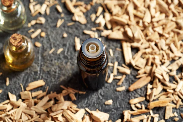Een Donkere Fles Aromatherapie Etherische Olie Met Witte Sandelhoutchips — Stockfoto