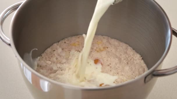 Pouring Fresh Milk Metal Bowl Containing Wheat Flour Eggs Yeast — Stock Video