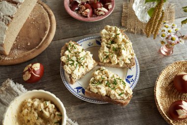 Paskalya yumurtaları, hardal ve süzme peynirden yapılmış üç dilim ekşi ekmek.