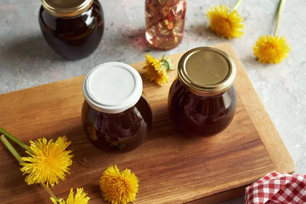 stock image Two jars of dandelion honey - syrup made from fresh flowers in spring