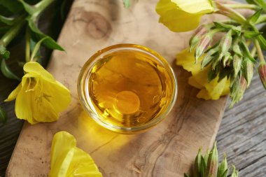 Taze bitkilerle dolu cam bir kasede çuha çiçeği yağı