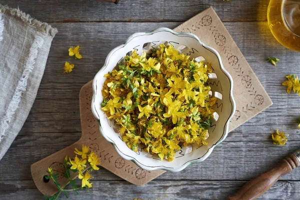 stock image St. John's wort or Hypericum flowers in a bowl, top view