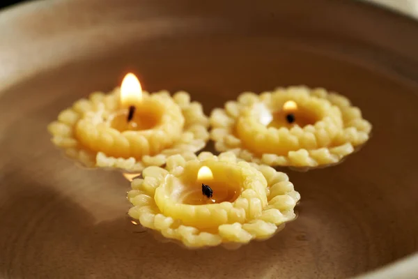 Candles made of bees wax floating in a bowl of water - old Christmas habit