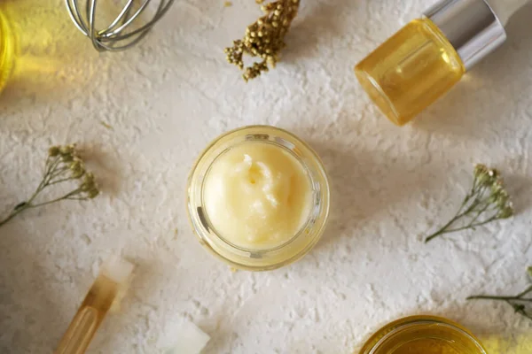 Shea butter with essential oils and herbs - ingredients for homemade cosmetics