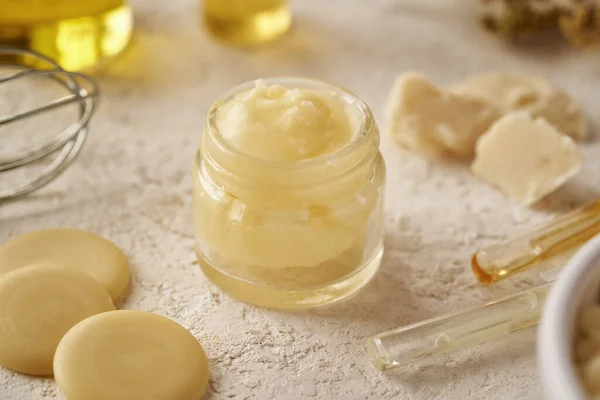 Homemade cosmetic cream made of shea butter, cocoa butter and essential oils