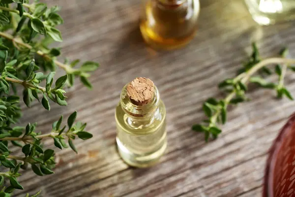 Thyme essential oil in a transparent glass bottle