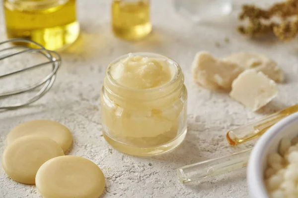 Shea butter and other ingredients for homemade cosmetics - cocoa butter, beeswax, essential oils