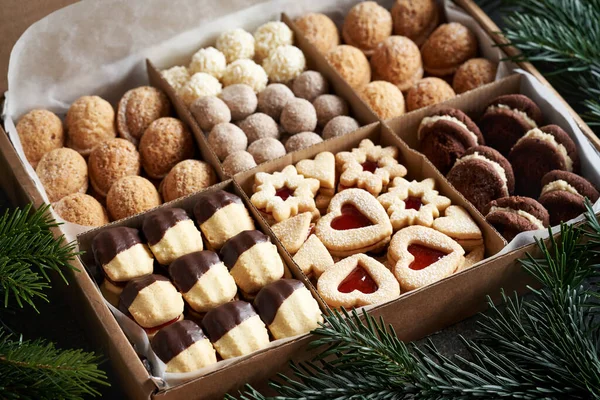 Variation of homemade Christmas cookies in a gift box on a table