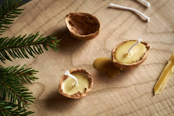 Making Christmas candles from bees wax and nut shells