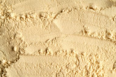 Beyazlatıcı protein tozundan yapılmış bej arka plan - sağlıklı besin takviyesi