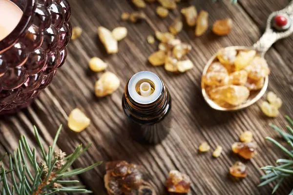 stock image Frankincense essential oil in a dark dropper bottle on a wooden table