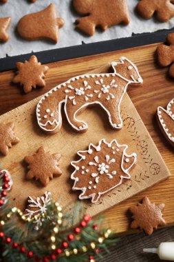 Hedgehog and fox shaped homemade gingerbread Christmas cookie decorated with white icing, top view clipart