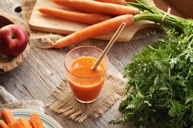 Bir bardak taze havuç suyu ve yeniden kullanılabilir bambu kamışı. Sıfır atık.
