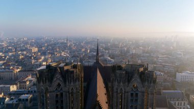 Aerial view of the twin towers of Reims Cathedral in France, rising above the historic cityscape. A stunning blend of Gothic architecture and urban charm.  clipart