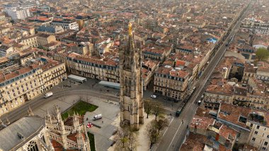 Bordeaux Fransa 'nın merkezindeki tarihi binaların ve tramvay hatlarının üzerinde yükselen altın heykelle Pey Berland Kulesi' nin hava manzarası.