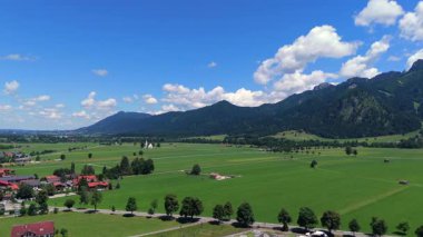 Bavyera kırsalının havadan çekilmiş küçük bir kilisesi ve Alpler yakınlarındaki açık tarım arazisi. 