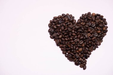 A heart shape made of roasted coffee beans on a clean white background. Perfect for use in coffee shop branding, Valentine s Day promotions, or lifestyle advertising related to coffee and love clipart