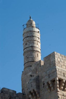 David's Citadel or the Tower of David rises above the medieval stone walls and ramparts of the Old City of Jerusalem, Israel.  clipart