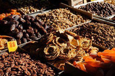 Ananas, papaya, hurma, badem, ceviz ve ceviz de dahil olmak üzere çeşitli kurutulmuş meyve ve fındıklar Kudüs, İsrail 'de bir açık hava üretim pazarında satılıyor.. 