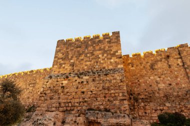 A section of the ancient stone ramparts and walls of the Old City of Jerusalem, illuminated by decorative lights on Mt. Zion.  clipart