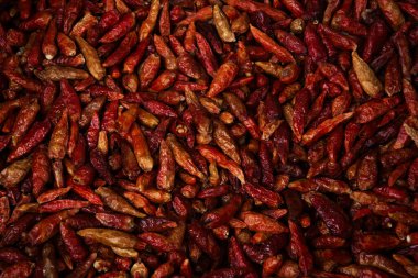 A large tray of dried, small, hot red chilli peppers.  clipart