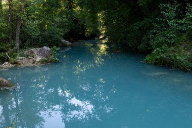 The milky waters of the Elsa River along the Diboratto Waterfall trail in Tuscany, central Italy, a popular destination for swimming and hiking.  clipart