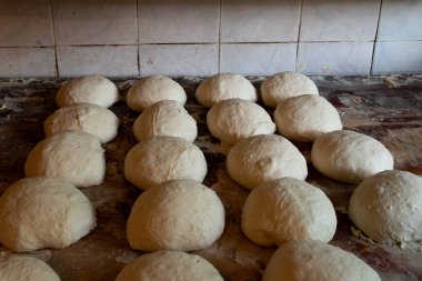 Gürcistan 'ın kano şeklindeki geleneksel ekmeğinin somunları içinde pişirilmeden önce taze şekillendirilmiş shot hamur yığınları..