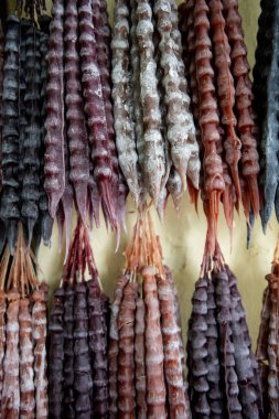 Churchkhela, a popular, traditional, Georgian, candle-shaped candy filled with nuts and fruit, which is dipped in grape must and juices, threaded onto a string and dried in the shape of a sausage. clipart