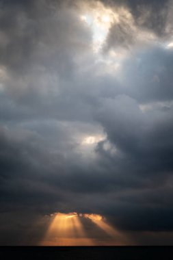 Altın güneş ışınları, güneş doğarken Güney İspanya 'nın Malaga kıyılarında Akdeniz' in üzerinde bulutların arasından fışkırır.. 