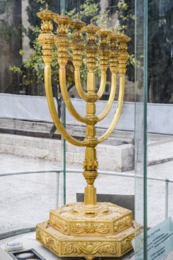 A replica of the golden Temple menorah, a seven-branched candelabrum that is described in the Hebrew Bible as having been used in the Tabernacle and in the Temple in Jerusalem, on display in the Old City of Jerusalem, Israel.  clipart