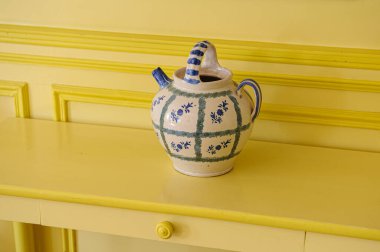 Fransız empresyonist ressam Claude Monet 'in Fransa' nın Giverny kentindeki eski evindeki sarı dolapta bulunan klasik mavi ve beyaz seramik çay demliği.. 
