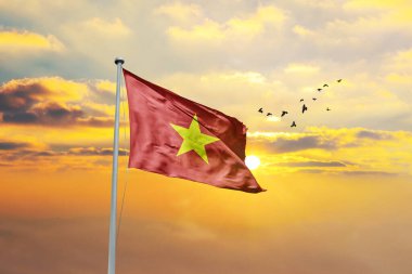 Waving flag of Vietnam against sunset or sunrise. Vietnam flag for Republic Day and Independence Day. clipart