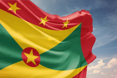 Grenada 'nın ulusal bayrağının günbatımına karşı rüzgarda dalgalanması.
