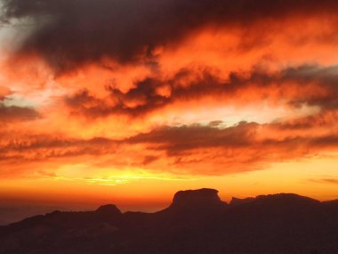 Bau Stone withlow clouds in the valley on a sunset clipart