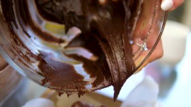 Kaşık, kasede yumuşak çikolata hamuru karıştırıyor. Yüksek kalite 4k görüntü