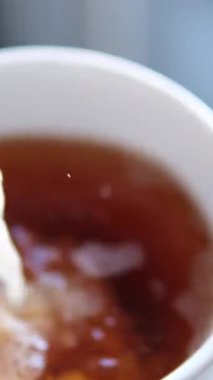 Siyah çay üst manzarasına süt dökmek. Taze demlenmiş yeşil çay seremonisi, sağlıklı bir sabah, arınma içeceği. Yüksek kalite 4k görüntü