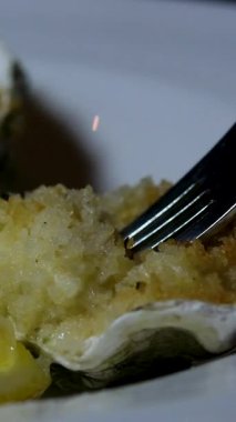 Zarif siyah tabak ve taze limonla lüks restoranlarda deniz taraklarına garnitür koyan kadın, güzel yemek ve yemek sanatının özünü yakalıyor.. 