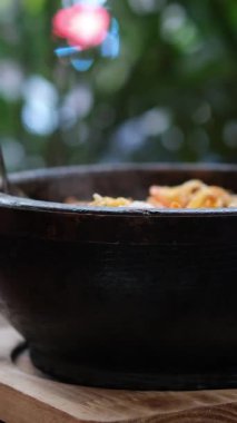 Asya restoranında bir kase etli erişte yiyen bir kadın. Çin çorbası yiyor. Erişte, otlar ve etten oluşuyor. Vietnam usulü erişte çorbası.