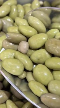 Çikolata kaplı çilek ezilmiş fındık ve dekoratif kağıt bardaklarda şekerleme. Taze yeşil çilek yaprakları. Döndürme. Makro atış. Yüksek kalite 4k görüntü