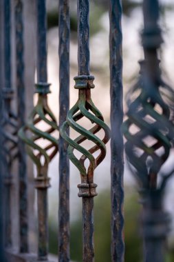 Karmaşık bükülmüş parmaklıkları olan eşsiz merdiven korkuluklarının yakın çekimi, güzel işçilik ve sanatsal tasarım sergileniyor.