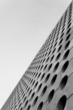 Enigmatic photo of a building facade featuring geometric circles arranged in precise rows and columns clipart