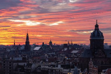 Amsterdam city skyline buildings during a dramatic pink sunset. Photo taken in the evening at Amsterdam Holland