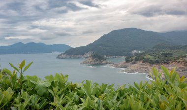 Beautiful mountain and beach view at Geojae Island in South Korea. Photo taken on a cloudy moist day clipart