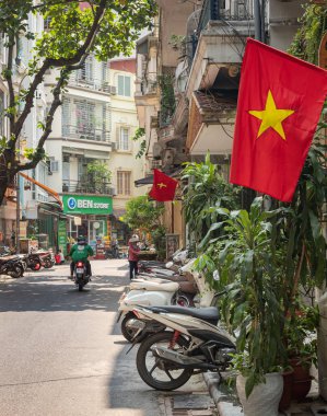 Hanoi Vietnam 'da kırmızı Vietnam bayrağı, sokaklar, sokak, motosikletler