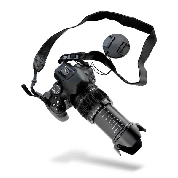 Beyaz arka planda uzun telefon lensleri olan siyah aynasız kamerayı havaya kaldırmak ya da düşürmek. Uzun zumlu siyah kamera. Mercek, odak uzaklığı ölçeğinde. Düşen kamera DSLR, kayışlı ve kapaklı, lens kapaklı. Profesyonel fotoğraf ekipmanları.