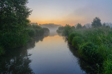 Yazın nehirde gün doğumu.