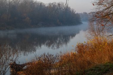 autumn landscape with fog and river.