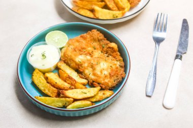 balık ve patates kızartması masada servis edilir.